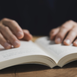 Reading philosophy book for personal development and habit experiments.